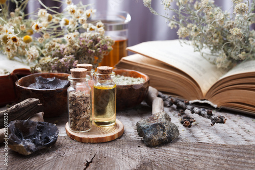 mystic still life with old book  amulets  stone  bottles. Witchcraft composition. Halloween and occult concept  magic ritual. mystical and homeopathic