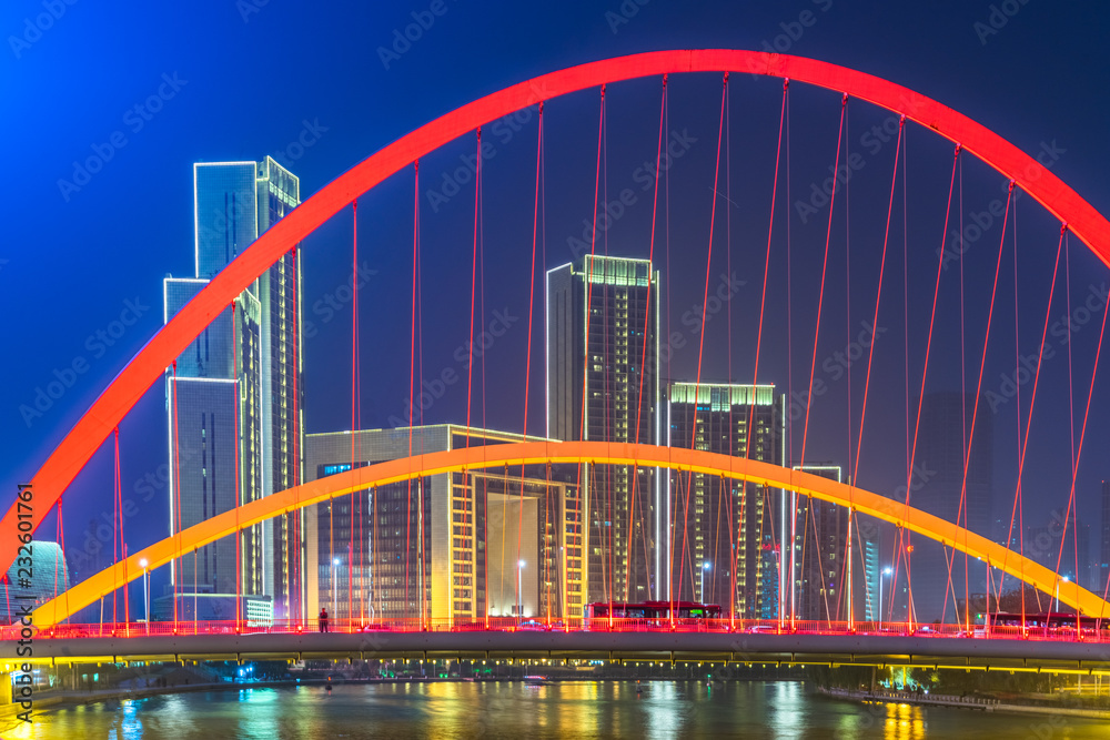 Obraz premium Tianjin Hai river waterfront downtown skyline with illuminated Dagu bridge,China.