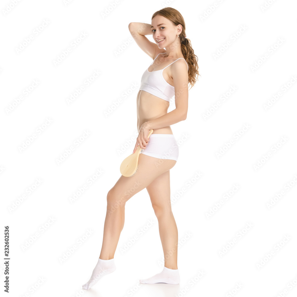 Beautiful woman brush from cellulite in hands on a white background. Isolation Beautiful woman brush from cellulite in hands on a white background. Isolation