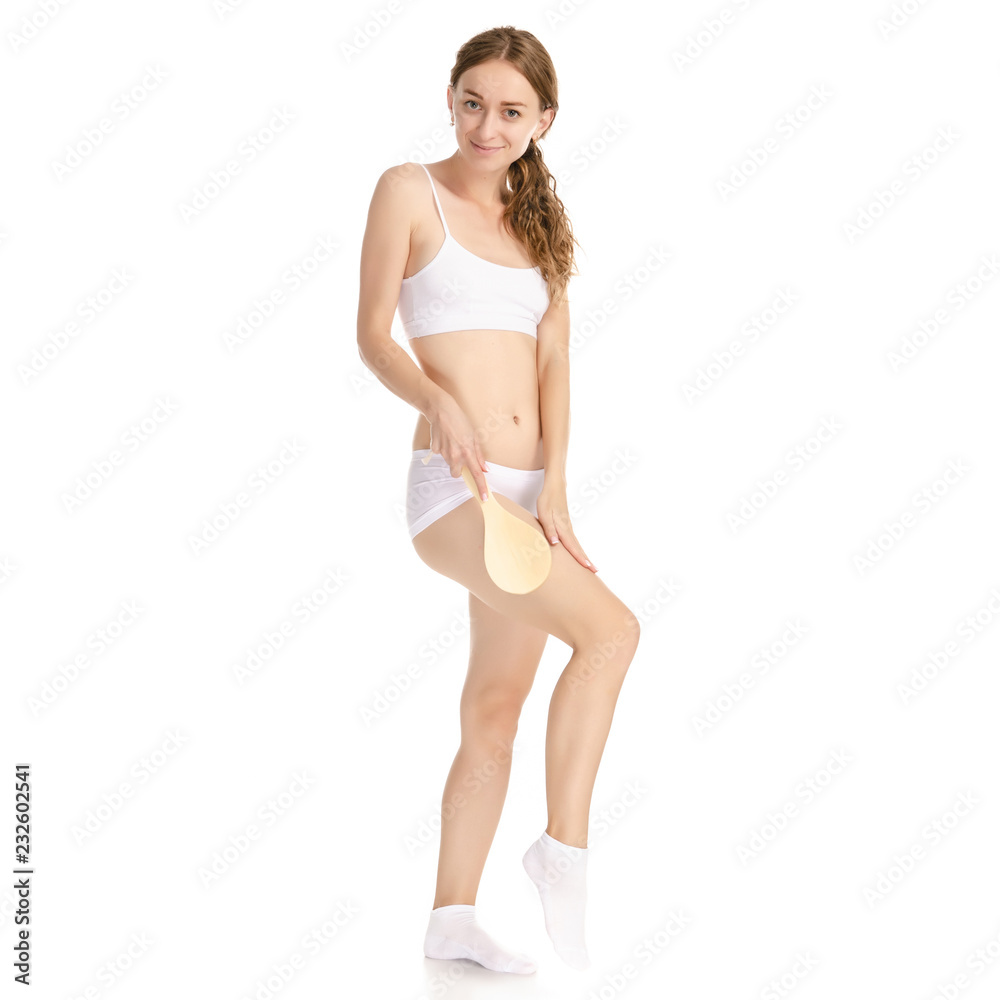 Beautiful woman brush from cellulite in hands on a white background. Isolation Beautiful woman brush from cellulite in hands on a white background. Isolation