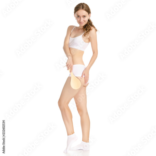Beautiful woman brush from cellulite in hands on a white background. Isolation