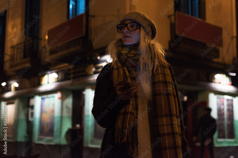 Stylish girl with phone on cold street Stylish girl with phone on cold street