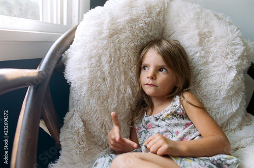 girl sitting quietly in chair photo