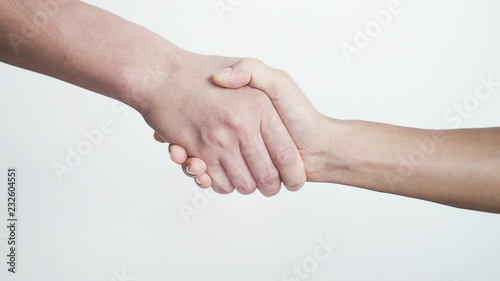 Shaking hands on white background. close up of female and male hands