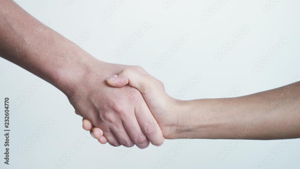 Shaking hands on white background. Close up of female and male shaking hands Shaking hands on white background. Close up of female and male shaking hands