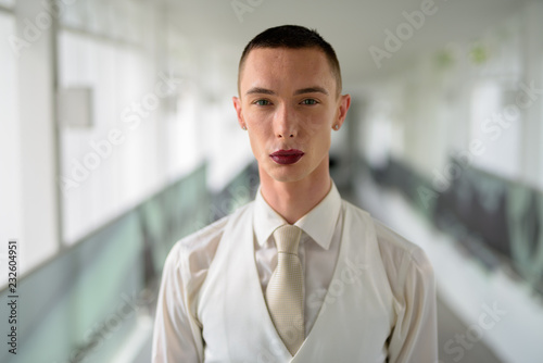 Young androgynous homosexual LGTB businessman wearing lipstick photo