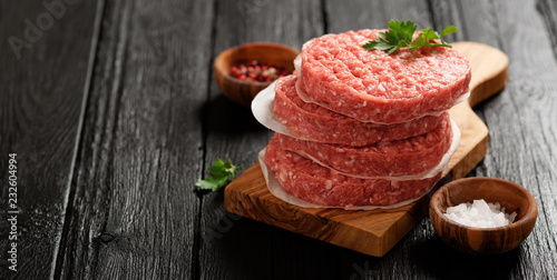 Fotografie Raw Ground beef meat Burger steak cutlets  on dark wooden background