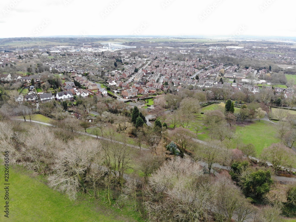 Aerial photo taken over Leeds showing houses, streets, paths and fields, taken in West Yorkshire