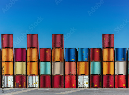 Stacked cargo containers in storage area of freight sea port terminal photo