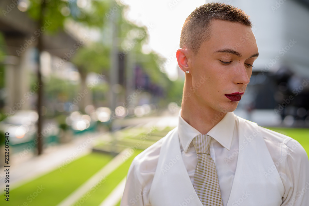 Young androgynous homosexual LGTB businessman wearing lipstick Young androgynous homosexual LGTB businessman wearing lipstick