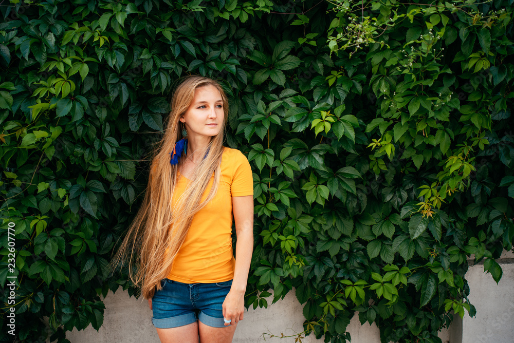 beautiful girl in shorts and yellow shirt outdoors beautiful girl in shorts and yellow shirt outdoors
