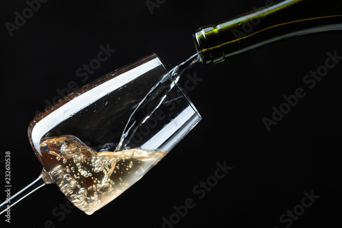 White wine being poured into wine glass.