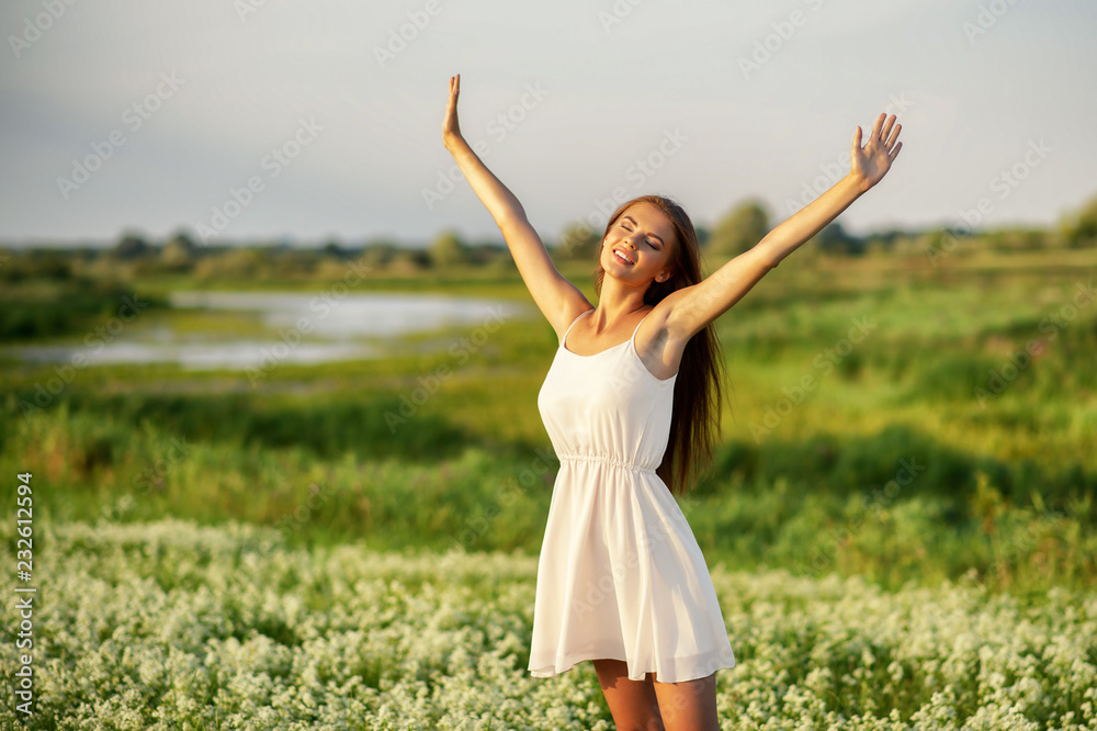 Happy and serene behavior woman outdoor with raised hands. Happy and serene behavior woman outdoor with raised hands.