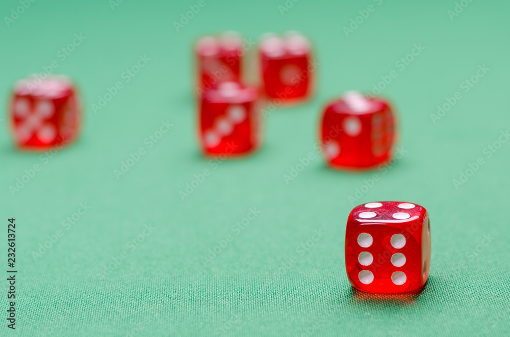 group of red dice on a green table are in a casino group of red dice on a green table are in a casino