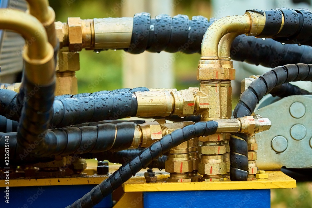 Closeup of manometer, measuring gas pressure. Pipes and valves on the background. Selective focus. Closeup of manometer, measuring gas pressure. Pipes and valves on the background. Selective focus.