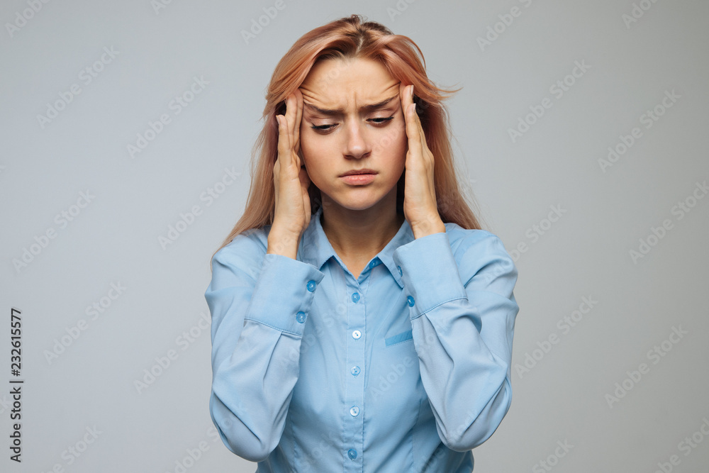 Pressure, strong migraine, feeling dizzy concept. Portrait of attractive tired stressful woman has a headache, tries to concentrate, gather with thoughts, keeps hands on temples, isolated. Pressure, strong migraine, feeling dizzy concept. Portrait of attractive tired stressful woman has a headache, tries to concentrate, gather with thoughts, keeps hands on temples, isolated.