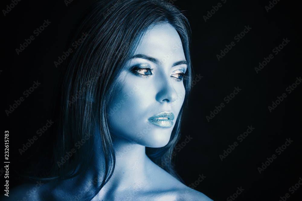 Portrait of a young woman model with blue make-up.