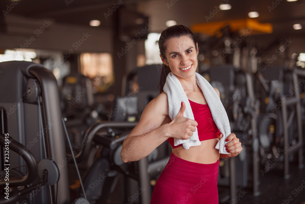 Fototapeta premium Smiling sportswoman gesturing thumb up