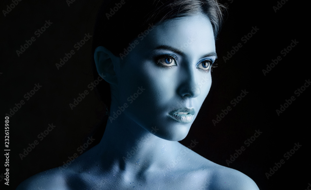 Portrait of a young woman model with blue make-up. Portrait of a young woman model with blue make-up.