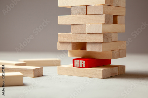 HR. Recruitment is the basis for building successful business. The tower of wooden balok and one block in the island with the inscription HR. Leader is the foundation of good team.