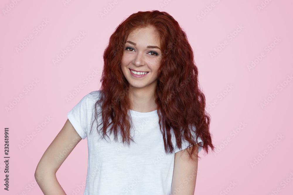 Cheerful ginger woman looking at camera Cheerful ginger woman looking at camera