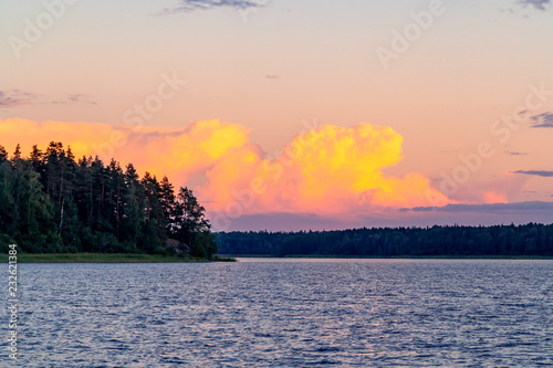 Beautiful clouds over the lake at sunset on a summer day