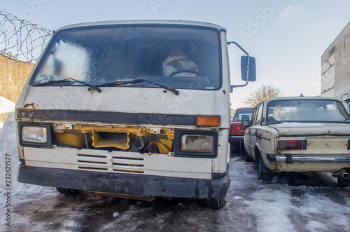 old, abandoned cars in winter