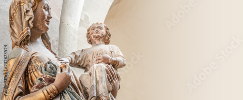 Ancient statue of Maria and Chris as baby at her hands, Magdeburg, Germany, details, closeup, smooth background