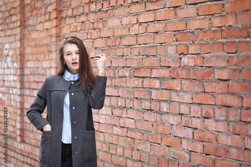 Young beautiful girl near red brick wall posing Young beautiful girl near red brick wall posing