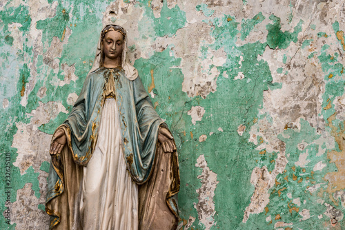 Wallpaper Mural Old Virgin Mary statue, peeling paint grunge wall background of an abandoned building Torontodigital.ca