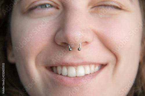 Nose Piercing septum. beautiful Caucasian woman smile