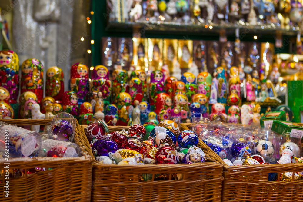 New Year's toys in wicker baskets.  A Color matryoshka.  Russian folk toys. Christmas Fair. A colorful tree toys.
