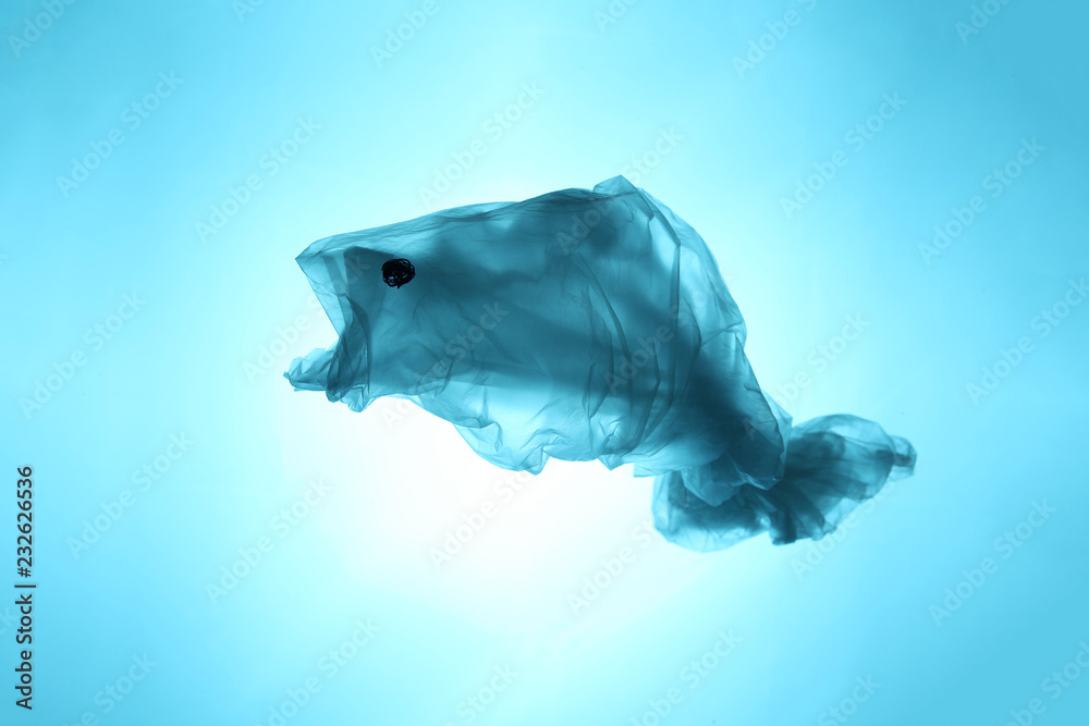 Obraz premium Plastic bags and garbage in the sea and ocean. Suffering sea animals. Fish symbol out of waste.
