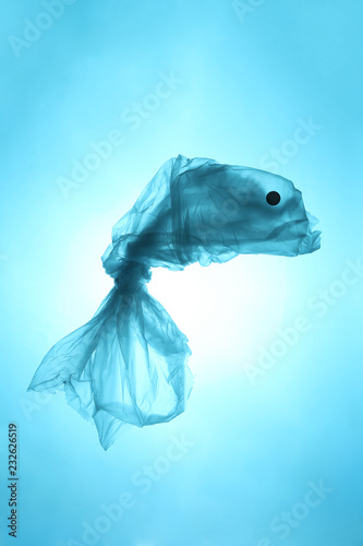 Plastic trash in the sea. Pollution of the world ocean waste. Silhouette of fish from a used plastic bag.