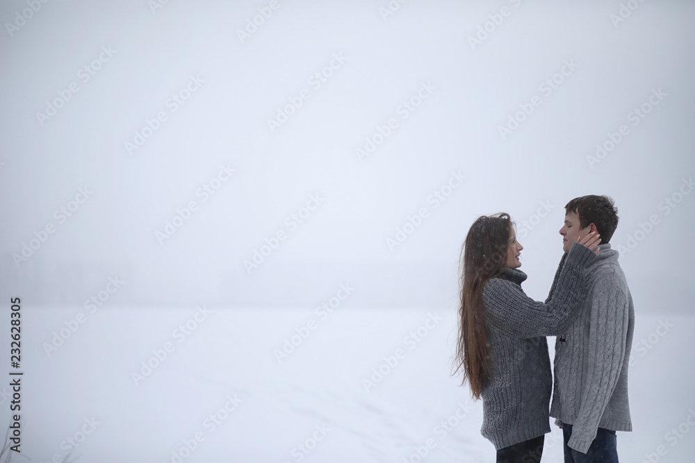 pair of lovers on a date winter afternoon in a snow blizzard pair of lovers on a date winter afternoon in a snow blizzard
