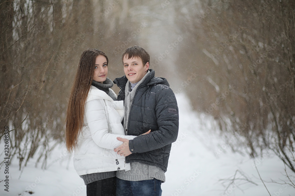 pair of lovers on a date winter afternoon in a snow blizzard pair of lovers on a date winter afternoon in a snow blizzard