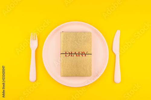Golden diary on serving table. Romantic concept