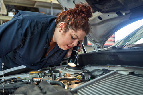 Female Mechanic Working on Cars in Her Shop