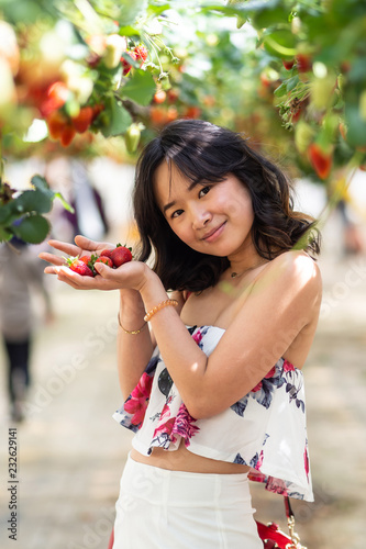 Young woman at a strawberry farm
