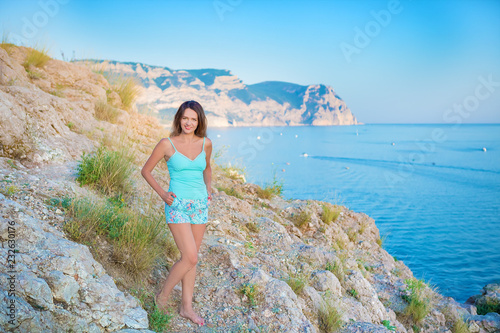 fashion model in lace dress outside posing ,yahts on background