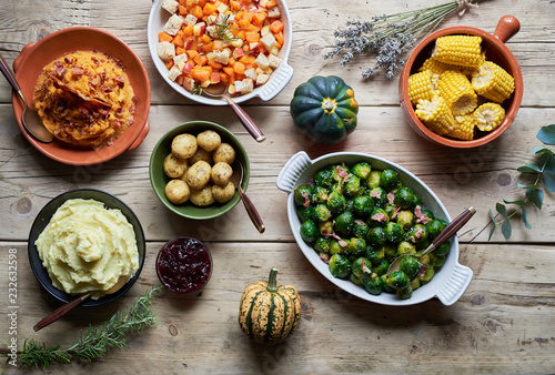 Turkey dinner and side dishes on a wood background.
