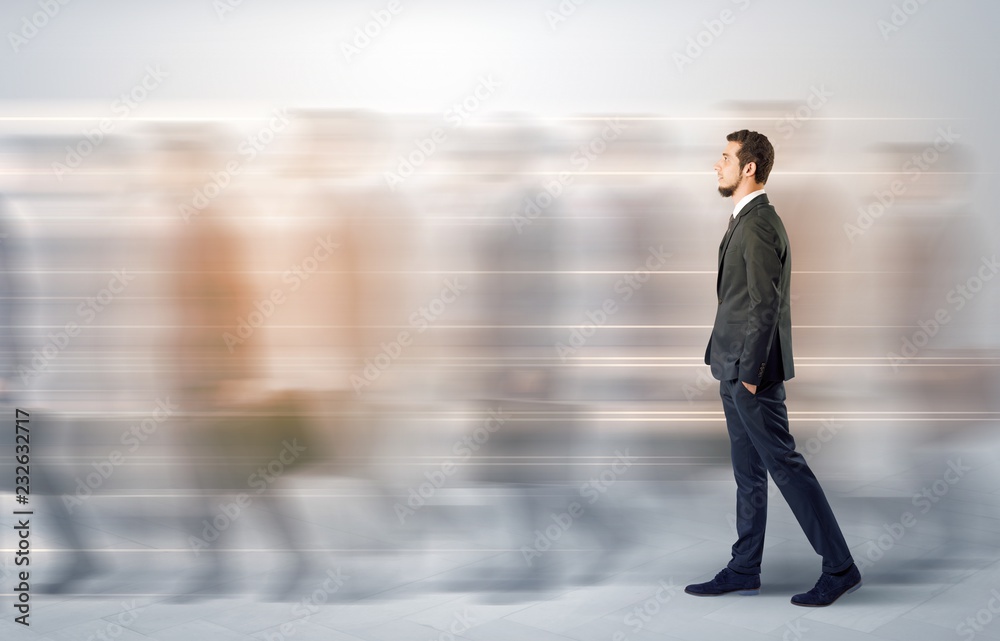 Young businessman with briefcase hurry up on a crowded street with blurred people around
Young businessman with briefcase hurry up on a crowded street with blurred people around