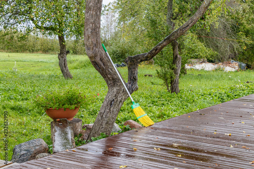in the garden, a broom suspended against a tree