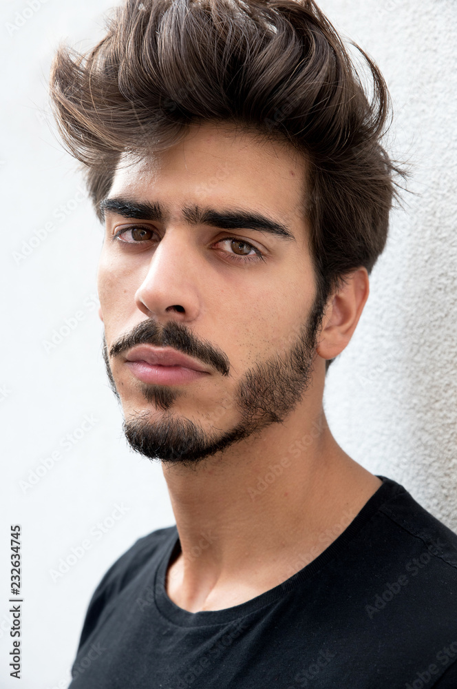 Portrait of a handsome young man with goatee looking at camera Portrait of a handsome young man with goatee looking at camera