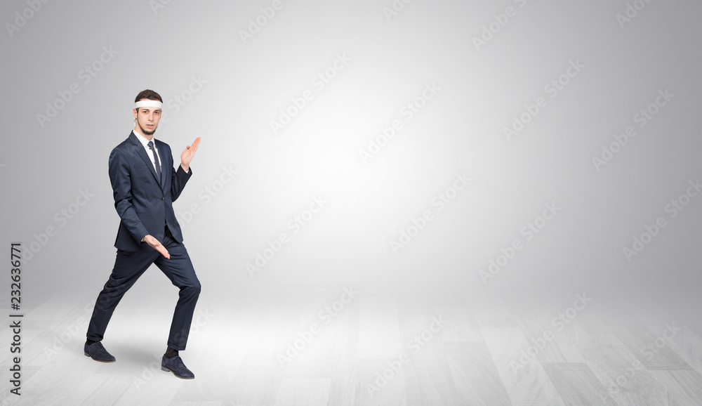 Young businessman in suit fighting in an empty space
Young businessman in suit fighting in an empty space