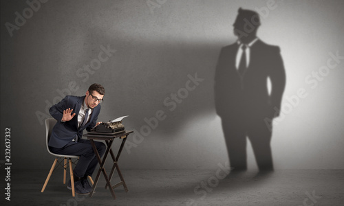 Shadow threatening hard worker man who is afraid 