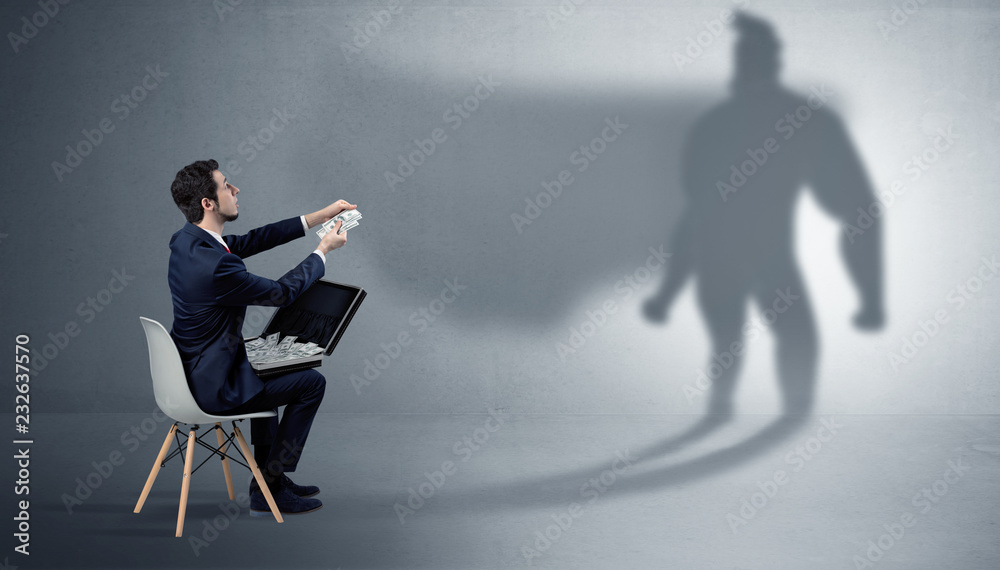 Humble businessman staying and offering stuffs to a superhero shadow
Humble businessman staying and offering stuffs to a superhero shadow