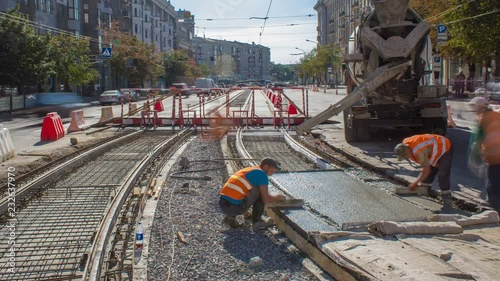 Concrete works for road maintenance construction with many workers and mixer timelapse photo