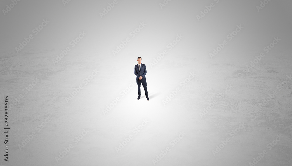 Young businessman standing alone in the middle of an empty space
