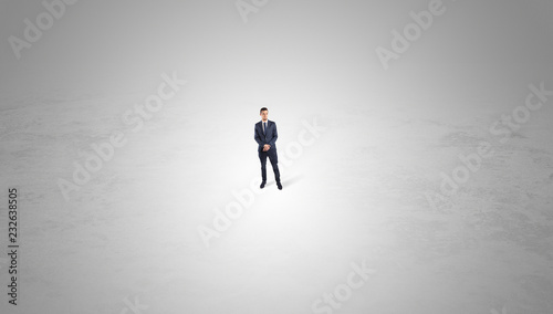 Young businessman standing alone in the middle of an empty space 